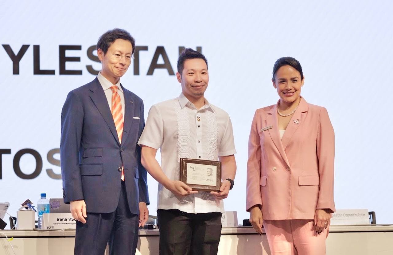 Myles Yeo Tan receiving the JCI Foundation Pin and Phil Pugsley Patron recognition, flanked by the 2026 JCI World President Alejandra Castillo